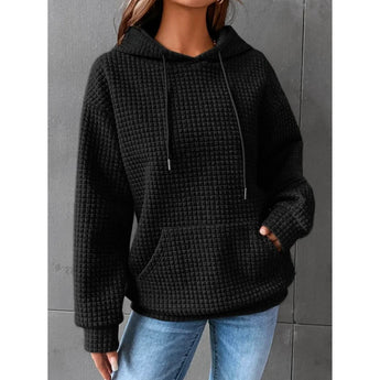 Textured pink waffle knit hoodie displayed with a cozy women's winter pullover design, featuring a relaxed fit suitable for cold weather.
