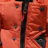 Black and red insulated winter coat with a high collar and full sleeves, designed for cold weather; the jacket is styled as outerwear and features a fashionable, padded textile suitable for winter conditions.