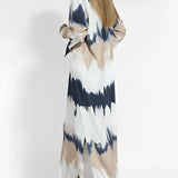 Tie-dye maxi dress with keyhole neckline featuring long sleeves, a fitted waist, and an elegant fall fashion design.