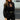 Trendy black mesh cutout high-neck blouse worn by a woman, highlighting the stylish high-neck design and sheer mesh detailing. The blouse is paired with eyewear, accentuating the fashionable look.