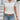 Trendy black V-neck blouse with lace shoulders and button-up front for women in white, size 2XL.