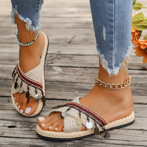Women's bohemian espadrille flat sandals featuring a colorful ankle chain, styled with a casual outfit including jeans, highlighting a fashion-forward look.