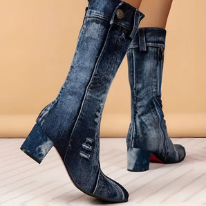 Denim knee-high boots in a blue jean-style design worn on human legs, showcasing the trendy fashion accessory with an electric blue hue.
