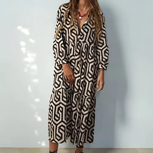 A woman wearing a trendy geometric print maxi dress in black with long sleeves and a boho chic design, perfect for fall fashion.