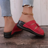 Trendy green women's flat sandals with bow-tie detail, designed for beachwear, shown on a model's feet.