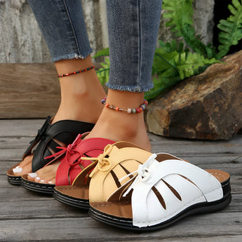 Trendy green women's flat sandals with a bow-tie design, suitable for beachwear.