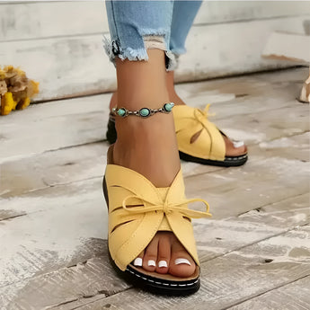 Trendy green women's flat sandals with a bow-tie design suitable for beachwear, displayed in a yellow color variant, size 43.