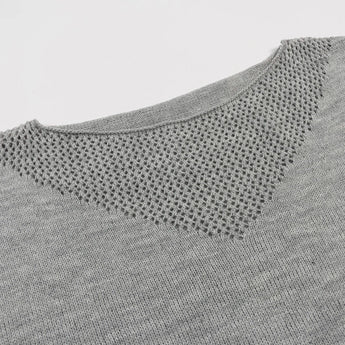 Trendy grey V-neck color-block geometric knit sweater women's pullover displayed against a simple background, highlighting the intricate pattern and stylish design.