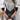 A trendy grey V-neck color-block geometric knit sweater for women, shown in a size 2XL, featuring a stylish pattern with black and gray colors, worn by a model paired with jeans.