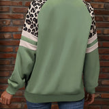 Trendy women's streetwear top in green with distinctive leopard print sleeves, featuring a comfortable pullover design.