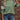Women's streetwear top featuring a trendy leopard print on the sleeves, paired with a green pullover design. The fashion-forward pullover has a relaxed neckline and is styled with casual jeans, showcasing a chic and modern look.