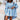 Light blue cut-out shoulder hoodie dress for women featuring long sleeves, a collar, and a relaxed fit. The dress falls above the thighs, highlighting a streetwear style with a trendy casual look.