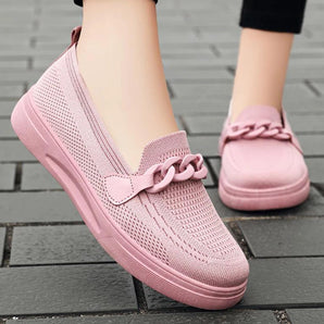Pink and white slip-on sneakers for women, featuring a breathable textile upper with purple and grey accents, ideal for summer wear.