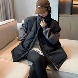 Oversized jacket with a collar and long sleeves, worn with a graphic hoodie and beige cargo pants, showcasing a streetwear fashion style.