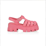 Trendy white platform sandals with an open toe, chunky sole, and buckle strap, displayed in vibrant pink color, size 43, worn on a human leg.
