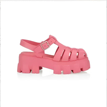 Trendy white platform sandals with an open toe, chunky sole, and buckle strap, displayed in vibrant pink color, size 43, worn on a human leg.