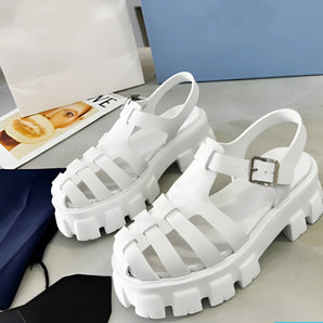 White platform sandals with an open toe, chunky sole, and buckle strap in size 43.