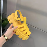 A pair of Trendy White Platform Sandals with an open toe, chunky sole, and buckle strap in size 43, shown in a yellow variant.