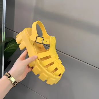 A pair of Trendy White Platform Sandals with an open toe, chunky sole, and buckle strap in size 43, shown in a yellow variant.