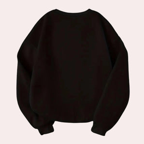 Trendy women's black oversized sweatshirt featuring balloon sleeves, showcased in a fashion-forward style.