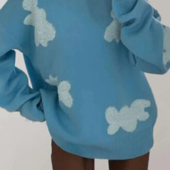 
A blue women's pullover with a cozy heart pattern design, featuring long sleeves and a comfortable neckline.
