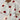 Trendy women's cozy pullover in white with grey and pink heart pattern, featuring long sleeves and a comfortable collar.