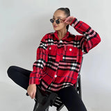 Trendy women's oversized plaid jacket in red, size XL, featuring a chic autumn streetwear style; model is wearing sunglasses and trousers.