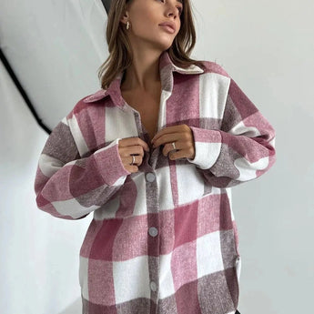 Trendy women's oversized plaid jacket in pink, shown on a model with long hair, styled in an autumn streetwear look. The jacket features a chic, relaxed fit, perfect for cooler weather.