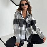 Women's oversized gray plaid jacket, styled for chic autumn streetwear, featuring long sleeves, paired with sunglasses and casual footwear.