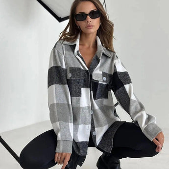 Women's oversized gray plaid jacket, styled for chic autumn streetwear, featuring long sleeves, paired with sunglasses and casual footwear.