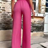 Trendy women's pink high-waisted palazzo pants, showcasing a lightweight and flowy design suitable for summer.