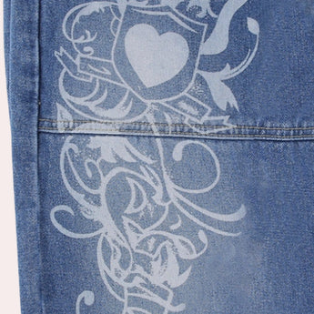 Trendy women's wide-leg jeans with an urban and hip-hop fashion print in shades of aqua and electric blue, featuring a bold, artistic pattern.