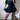 Trendy women's urban chic outfit featuring a black tee, pleated skirt, and leopard print boots.