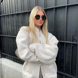 Trendy Women's White Faux Fur Oversized Jacket worn by a model with sunglasses, showcasing a chic winter fashion style.