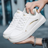 Trendy white low-top sneakers with gold accents, featuring a sleek design suitable for casual wear.
