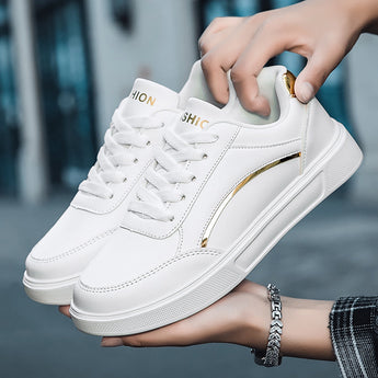 Trendy white low-top sneakers with gold accents, featuring a sleek design suitable for casual wear.