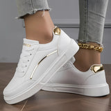 
White low-top sneakers for women featuring stylish gold accents, shown against a neutral background.