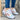 Trendy women's white sneakers with bold soles, featuring a stylish mix of azure and electric blue accents.
