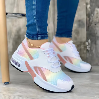 Trendy women's white sneakers with bold soles, featuring a stylish mix of azure and electric blue accents.