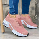 Trendy women's white sneakers with bold pink soles, shown in a size 43, worn by a person, highlighting the fashionable and vibrant design.