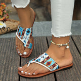 Tribal pattern women's sandals featuring a boho chic design, worn by a person with a focus on the footwear against a contrasting background.