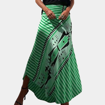 Bohemian maxi skirt with yellow tribal print and wrap style detailing, shown in green color and size XL, being modeled by a person. The skirt features a flowing, elegant design suitable for casual and bohemian fashion styles.