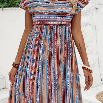 A woman wearing a boho chic summer dress featuring a tribal print, V-neckline, and A-line midi silhouette.