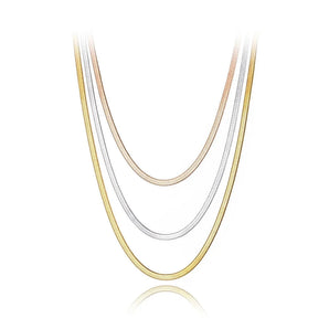 Triple layered Lokaer titanium necklace in gold, silver, and rose gold displayed on a white background.