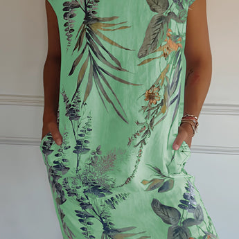 
A green tropical botanical print sleeveless summer shift dress designed as beachwear, displayed in size 3XL. The dress features a one-piece garment design with a round neck and is patterned with vibrant botanical prints.