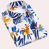 Flowery blue Hawaiian shirt in size 2XL featuring a tropical floral pattern in blue and white, short sleeves, and a classic collar, ideal for beachwear and summer outings.