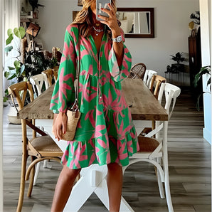 Tropical print button-up mini dress in green and pink, featuring short sleeves and a fitted waist.