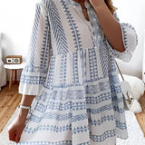 Tropical print button-up mini dress in blue, featuring a vibrant summer style with patterns and short sleeves, modeled to showcase its fashionable fit and design.