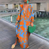 Luxurious orange tropical print long sleeve kaftan designed for beachwear, featuring a flowing silhouette and elegant leisure style suitable for travel.