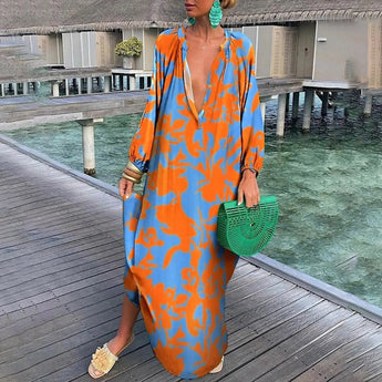Luxurious orange tropical print long sleeve kaftan designed for beachwear, featuring a flowing silhouette and elegant leisure style suitable for travel.